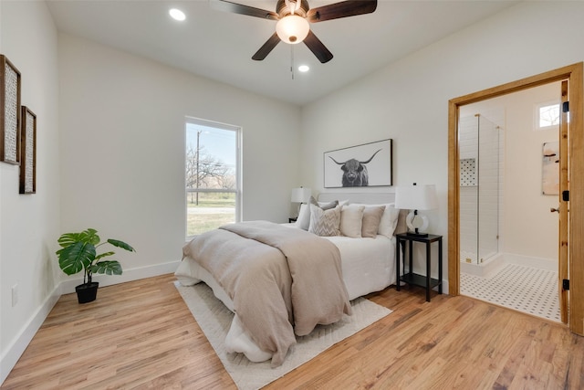 bedroom with ceiling fan, ensuite bathroom, and light hardwood / wood-style floors