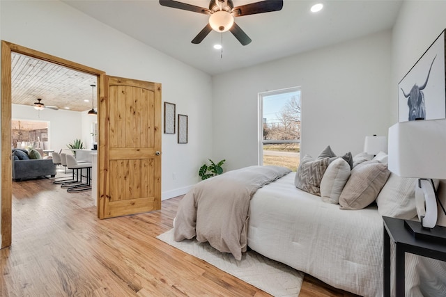 bedroom featuring wood-type flooring, lofted ceiling, and ceiling fan