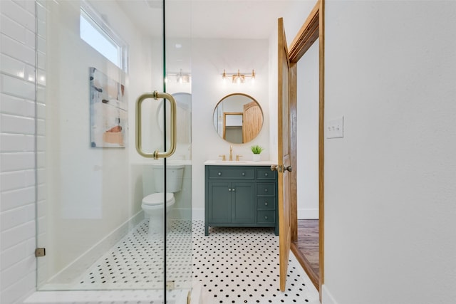 bathroom with vanity, tile patterned flooring, a shower with door, and toilet