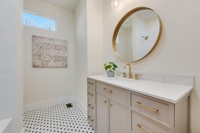 bathroom featuring tile patterned floors, vanity, and a shower