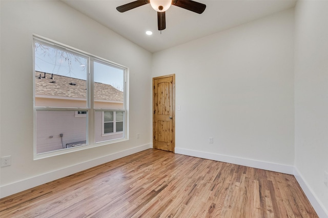 spare room featuring ceiling fan and light wood-type flooring