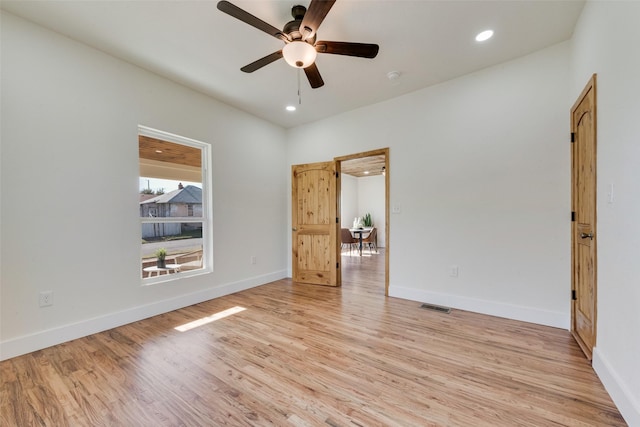 empty room with ceiling fan and light wood-type flooring