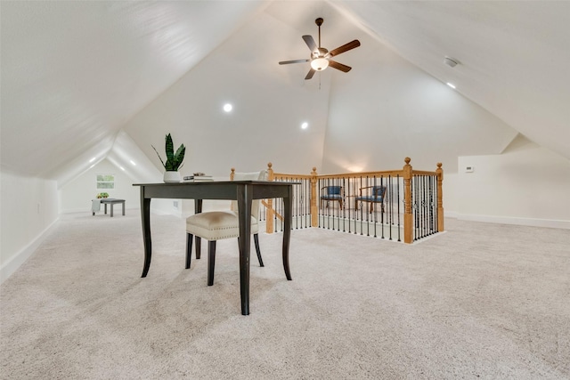 carpeted office space with ceiling fan and vaulted ceiling