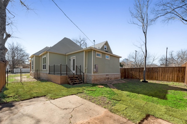 rear view of house featuring a yard and a patio area