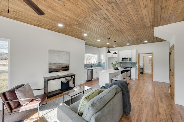 living room with light wood-type flooring, sink, and wooden ceiling