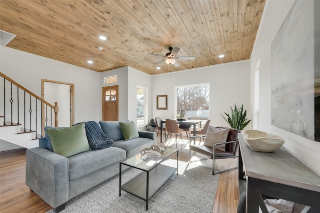 living room featuring ceiling fan, ornamental molding, hardwood / wood-style floors, and wooden ceiling