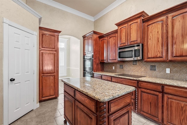 kitchen with crown molding, backsplash, black appliances, and light tile patterned floors