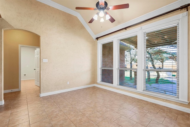 tiled empty room featuring ceiling fan, crown molding, and lofted ceiling