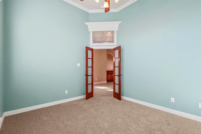 unfurnished room with ceiling fan, carpet, french doors, and ornamental molding