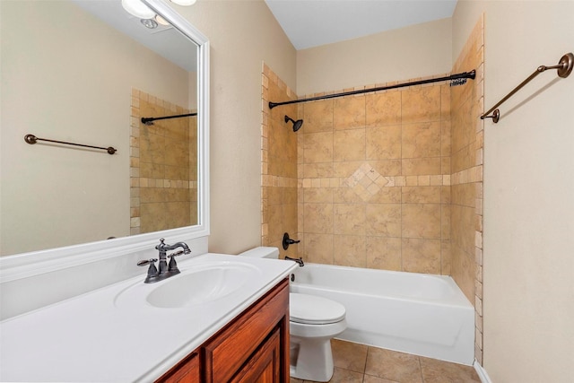 full bathroom featuring vanity, toilet, tiled shower / bath, and tile patterned flooring