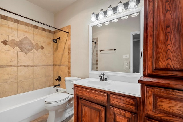 full bathroom with toilet, vanity, and tiled shower / bath