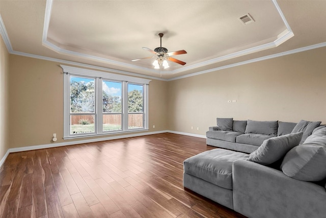 unfurnished living room featuring crown molding, hardwood / wood-style floors, ceiling fan, and a raised ceiling