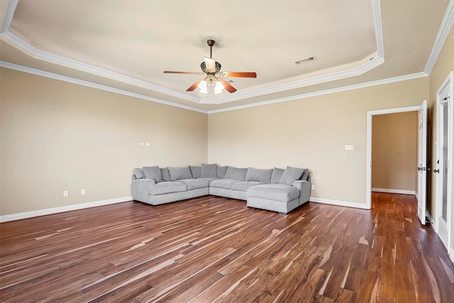 unfurnished living room featuring ceiling fan, dark wood-type flooring, ornamental molding, and a raised ceiling