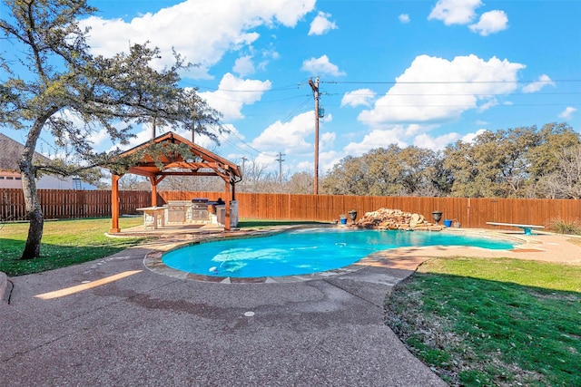 view of swimming pool with a diving board, an outdoor kitchen, a patio area, a gazebo, and a yard