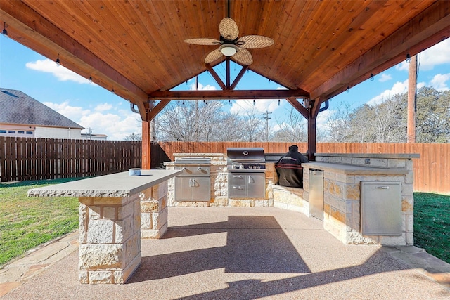 view of patio with a grill, ceiling fan, a gazebo, and area for grilling