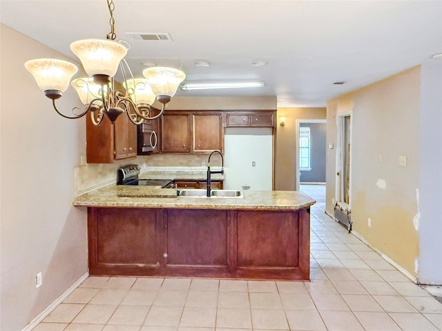 kitchen featuring light tile patterned flooring, appliances with stainless steel finishes, pendant lighting, a chandelier, and kitchen peninsula