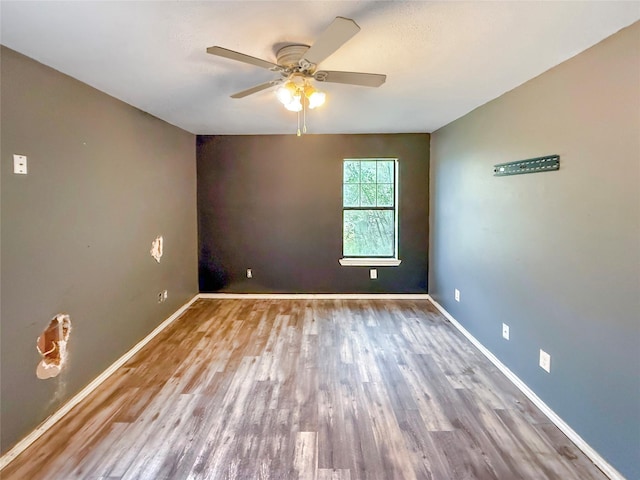 spare room with hardwood / wood-style flooring and ceiling fan