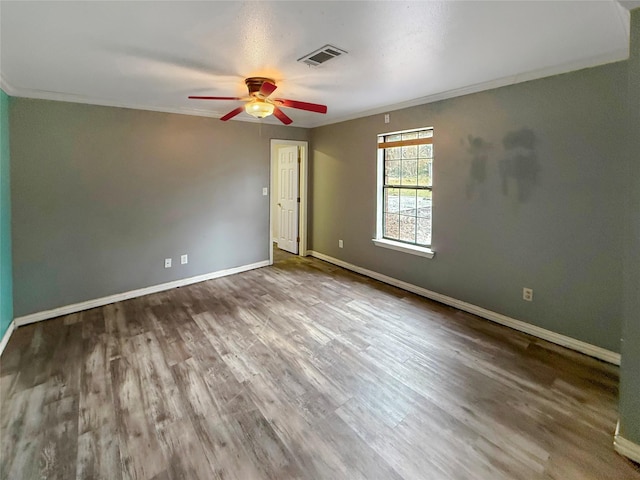 spare room with crown molding, ceiling fan, and hardwood / wood-style floors