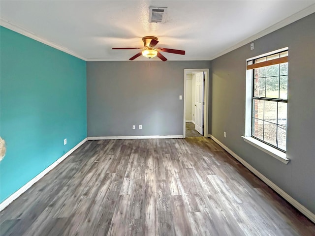 spare room with ceiling fan, ornamental molding, and dark hardwood / wood-style floors