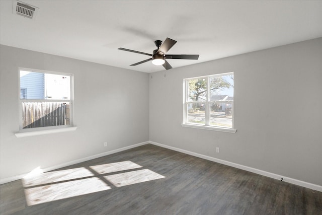 spare room with ceiling fan and dark wood-type flooring