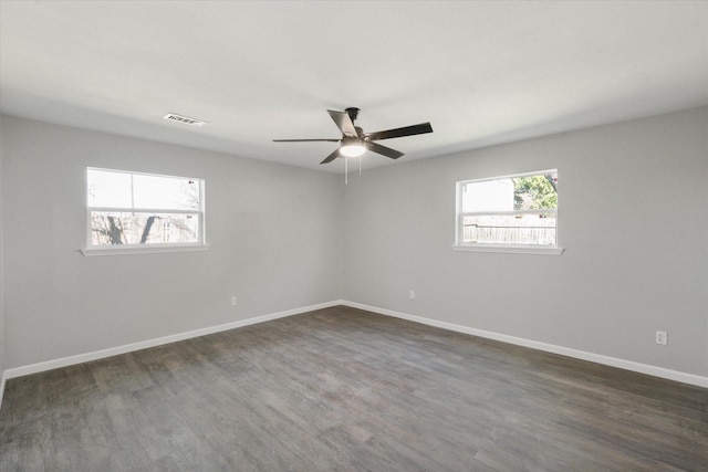 spare room featuring ceiling fan and dark hardwood / wood-style flooring