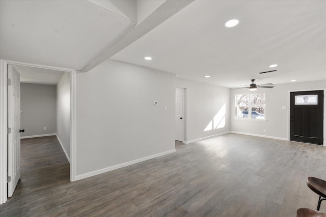 unfurnished living room with ceiling fan and dark hardwood / wood-style floors