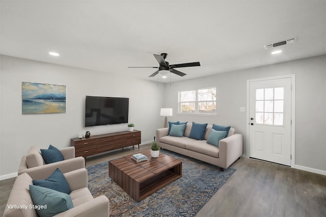 living room featuring ceiling fan and wood-type flooring