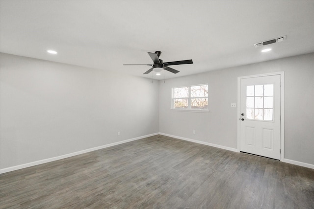 empty room featuring ceiling fan and dark hardwood / wood-style flooring