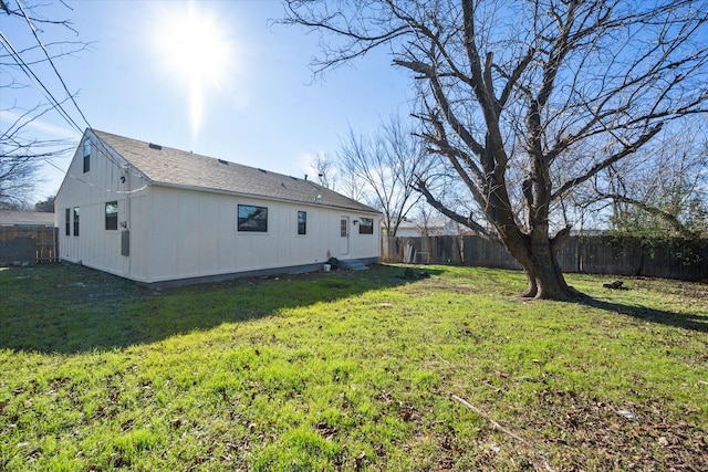 rear view of house featuring a lawn