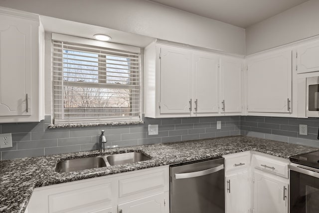 kitchen featuring sink, white cabinetry, appliances with stainless steel finishes, and decorative backsplash