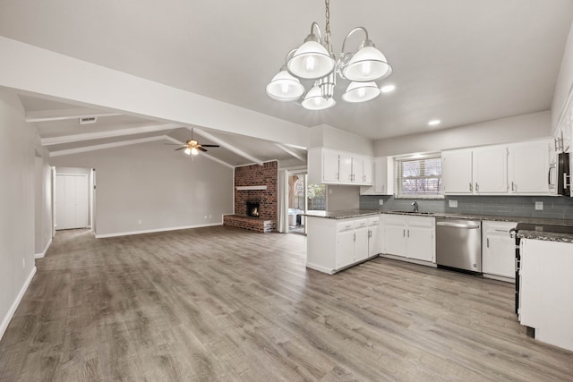 kitchen featuring lofted ceiling with beams, sink, white cabinetry, and stainless steel appliances