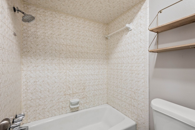 bathroom with tiled shower / bath combo and toilet