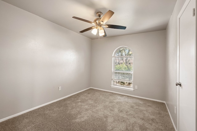 spare room featuring ceiling fan and light colored carpet