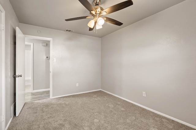 carpeted spare room with ceiling fan