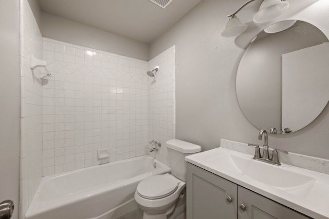 full bathroom featuring toilet, vanity, and tiled shower / bath