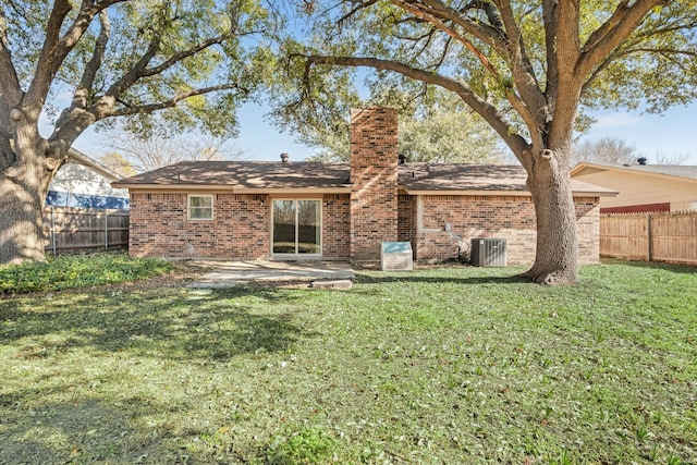 back of property featuring a patio area, central air condition unit, and a yard