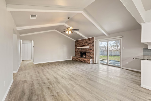 unfurnished living room with ceiling fan, light hardwood / wood-style flooring, a fireplace, and lofted ceiling