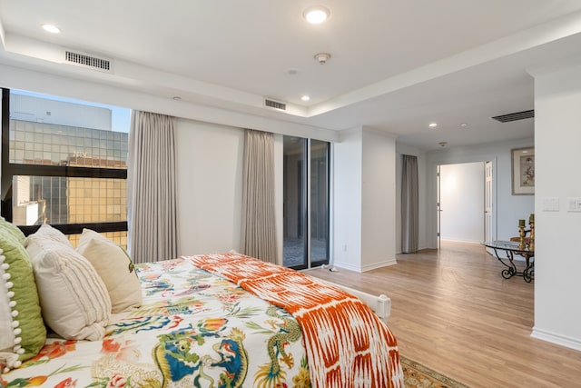 bedroom featuring light hardwood / wood-style floors and access to outside