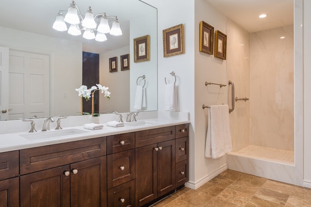 bathroom with vanity and a tile shower