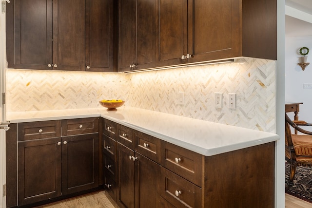 5909 Luther Ln Unit 2000, Dallas, TX 75225 - kitchen featuring light wood-style floors, light countertops, and decorative backsplash