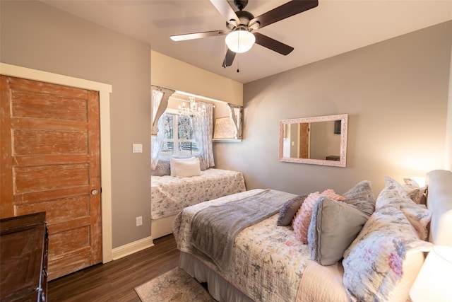 bedroom with dark hardwood / wood-style floors and ceiling fan