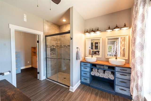 bathroom with hardwood / wood-style flooring, an enclosed shower, and vanity