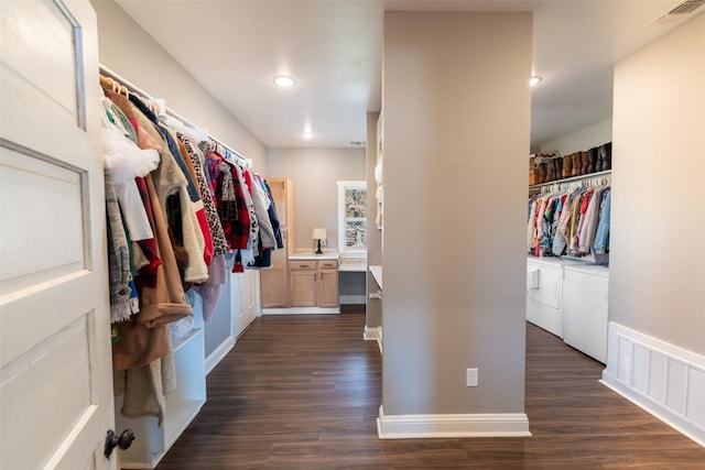 walk in closet featuring dark wood-type flooring and washing machine and clothes dryer