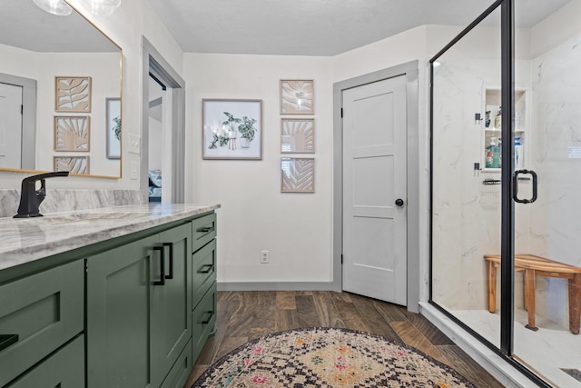 bathroom featuring vanity, hardwood / wood-style floors, and a shower with door