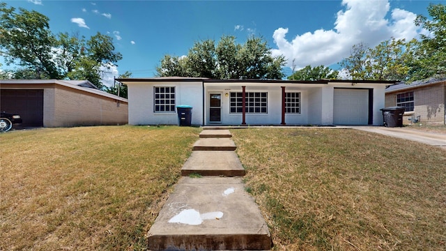 single story home with a front yard and a garage