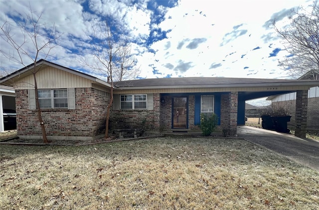 ranch-style home with a carport and a front lawn