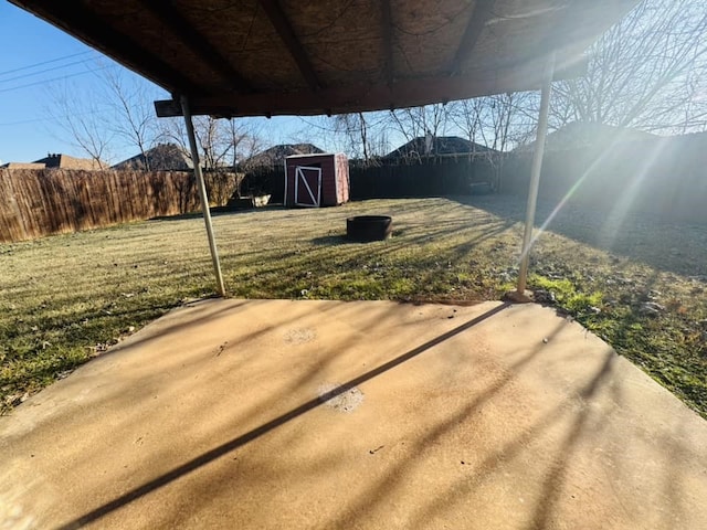 view of yard featuring a patio and a storage unit