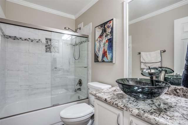 full bathroom featuring vanity, ornamental molding, shower / bath combination with glass door, and toilet