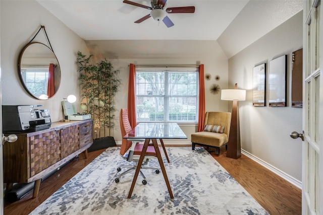 office area with dark wood-type flooring, ceiling fan, and vaulted ceiling