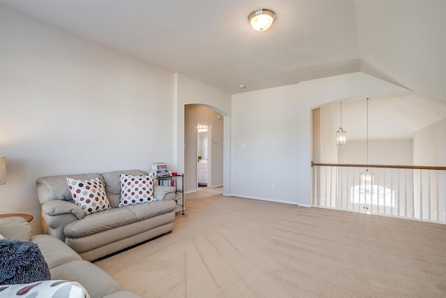 carpeted living room featuring vaulted ceiling